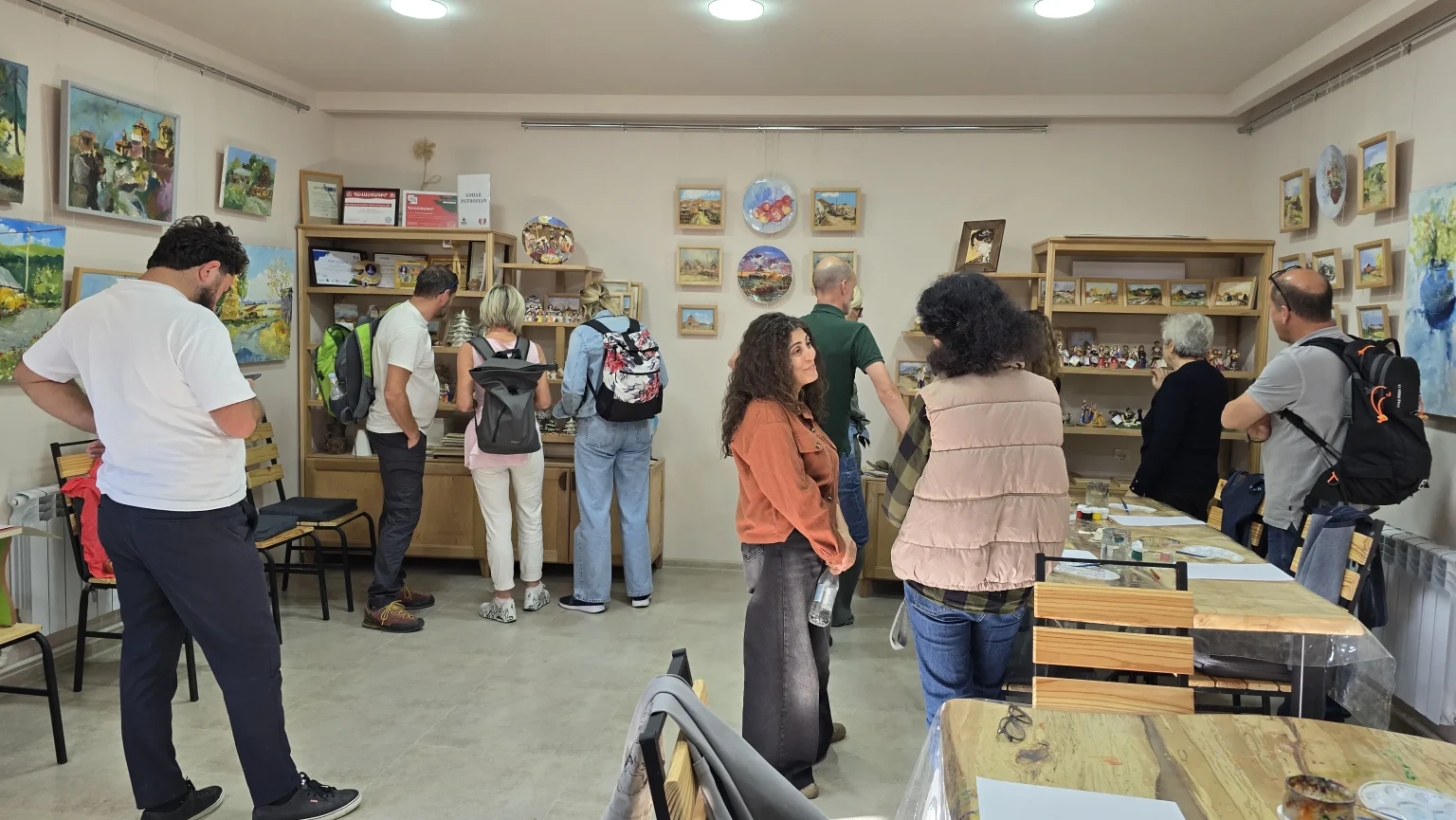 Visitors standing at the shelves of ceramic figurines in the gallery